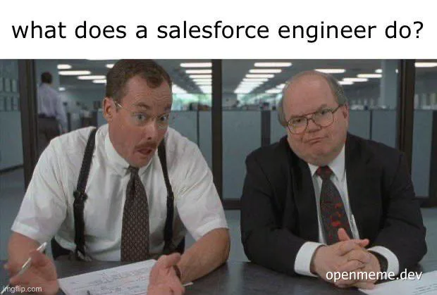 Two men sitting at a desk looking confused