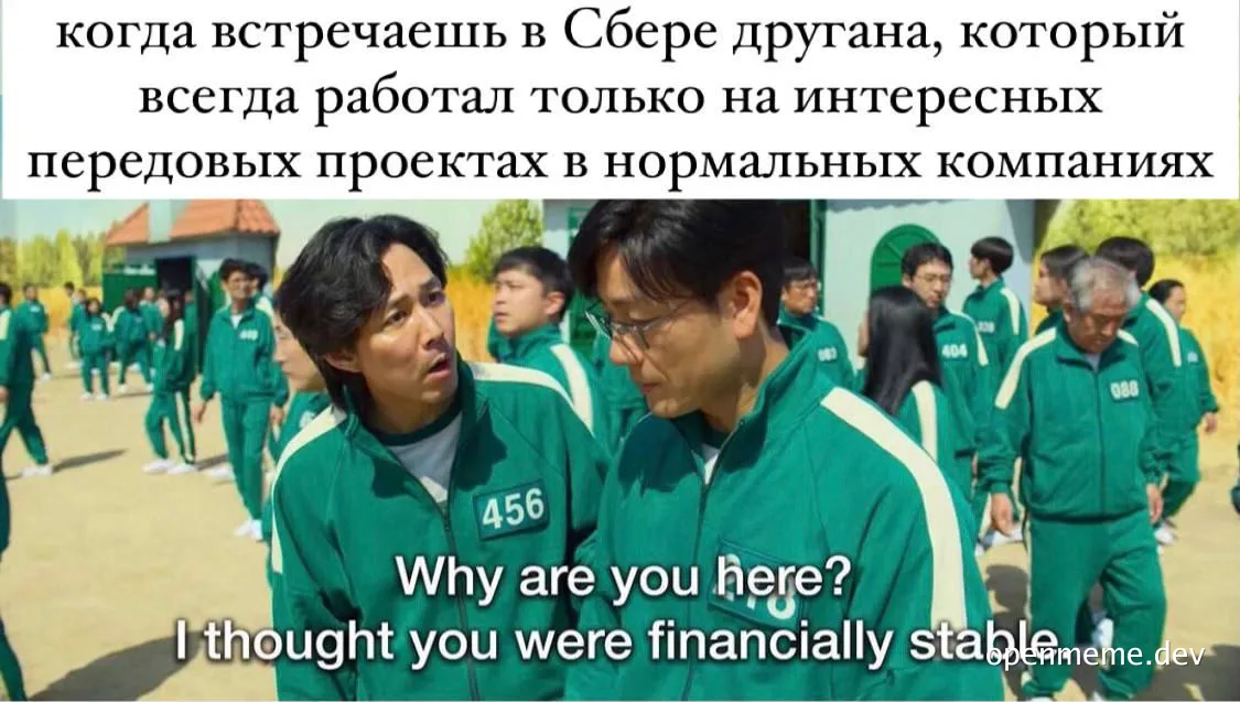 Two men in green tracksuits with white stripes and numbered patches talking to each other, with a group of people in similar outfits in the background.