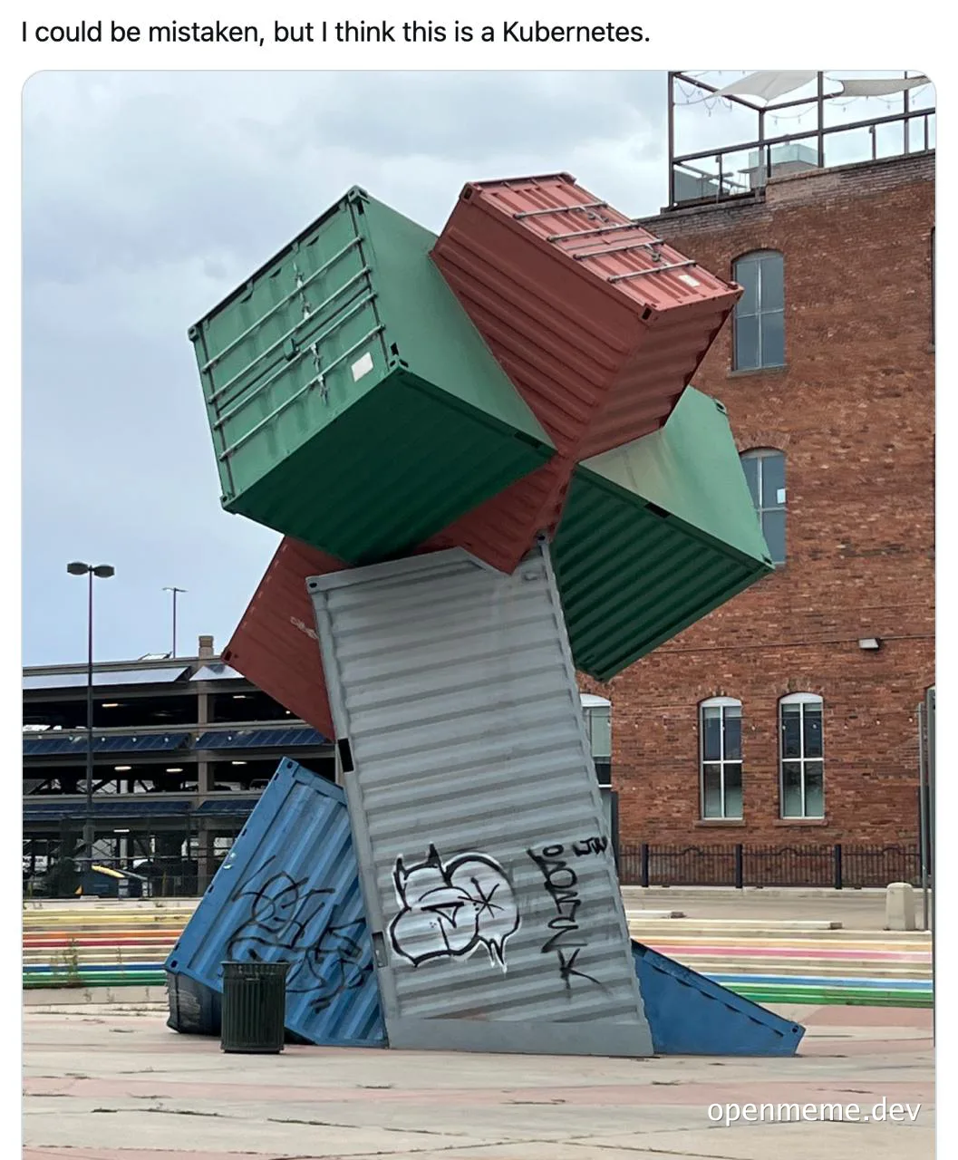 a sculpture of stacked shipping containers with the caption 'I could be mistaken, but I think this is a Kubernetes'
