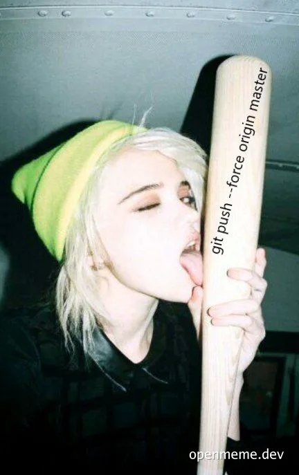 Blonde woman in yellow beanie kissing a large wooden bat with 'git push --force origin master' text