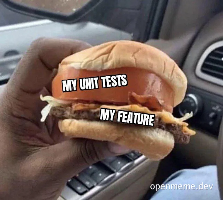 a hand holding a burger with two layers labeled 'my unit tests' and 'my feature'