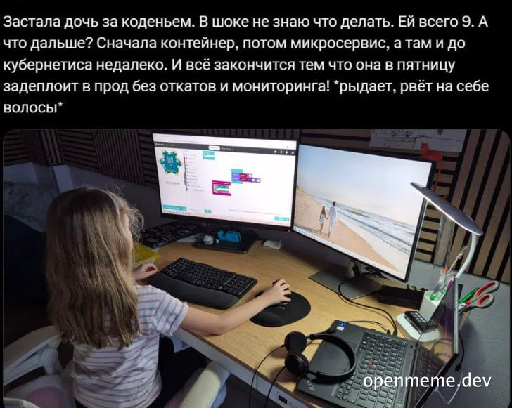 a young girl sitting at a desk with two computer monitors