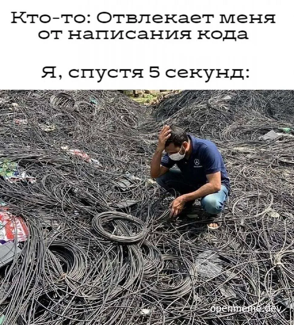 Man surrounded by tangled wires with frustrated expression