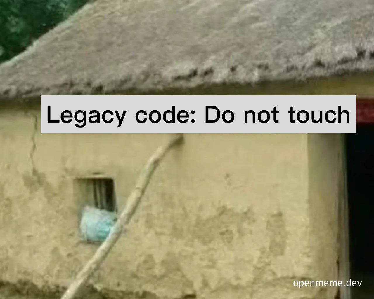 a hut with a thatched roof and a sign that reads 'Legacy code: Do not touch'