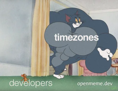 Tom cat with a large cloud representing timezones chasing Jerry representing developers