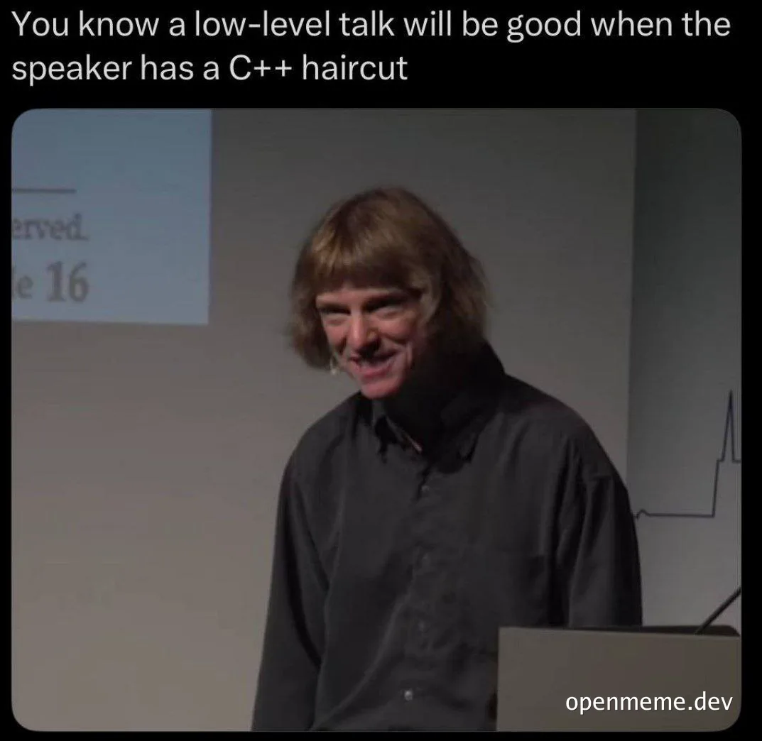 a man with a mullet haircut, implying a low-level talk about C++