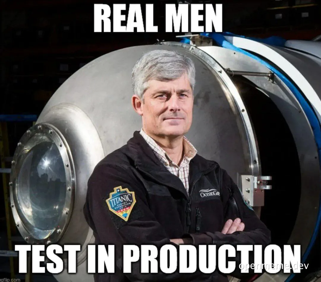 a man in a black jacket with a patch on the sleeve standing in front of a large metal door with the text 'REAL MEN TEST IN PRODUCTION'