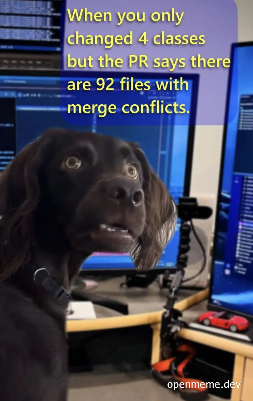 Surprised dog in front of computer screens with text 'When you only changed 4 classes but the PR says there are 92 files with merge conflicts'