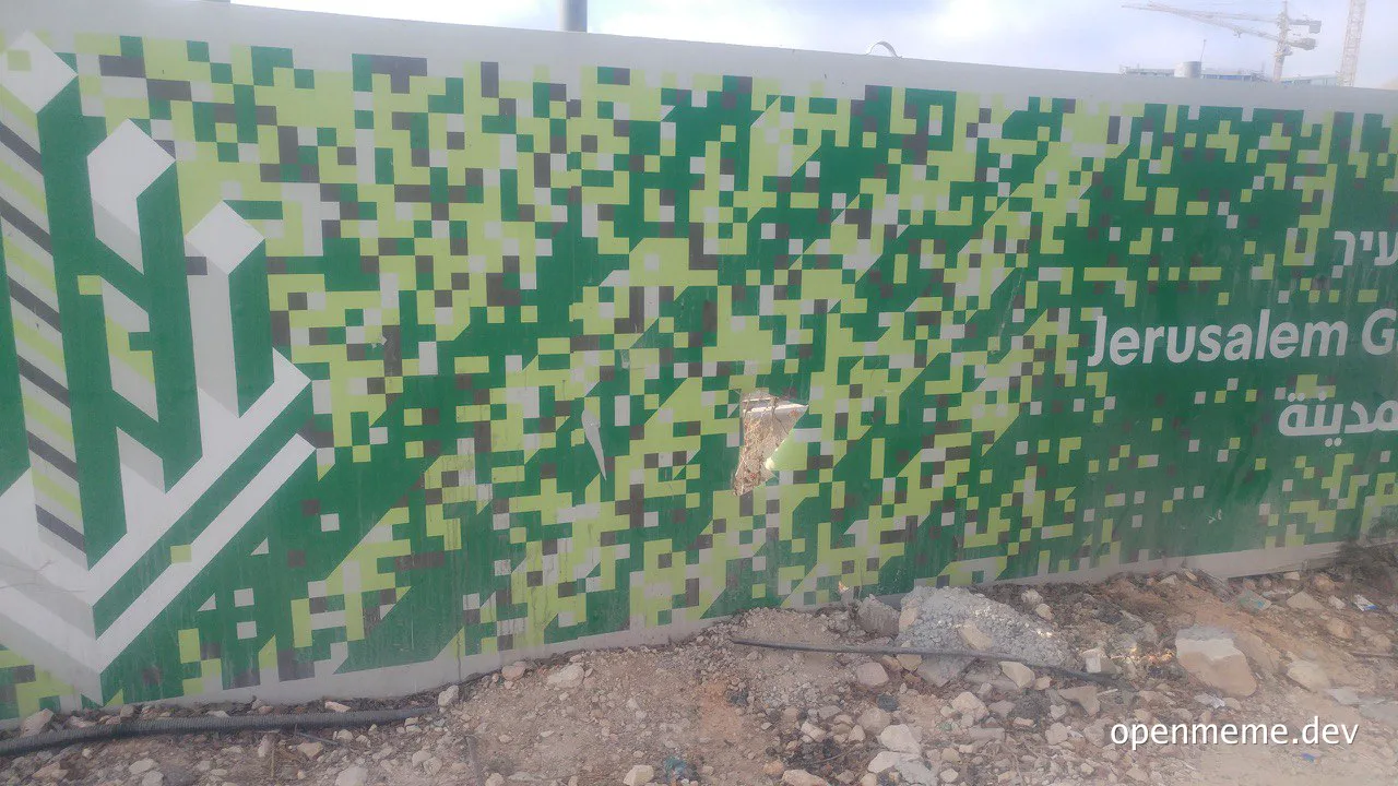 Green and white pixelated glitch mural on a wall with text reading Jerusalem G