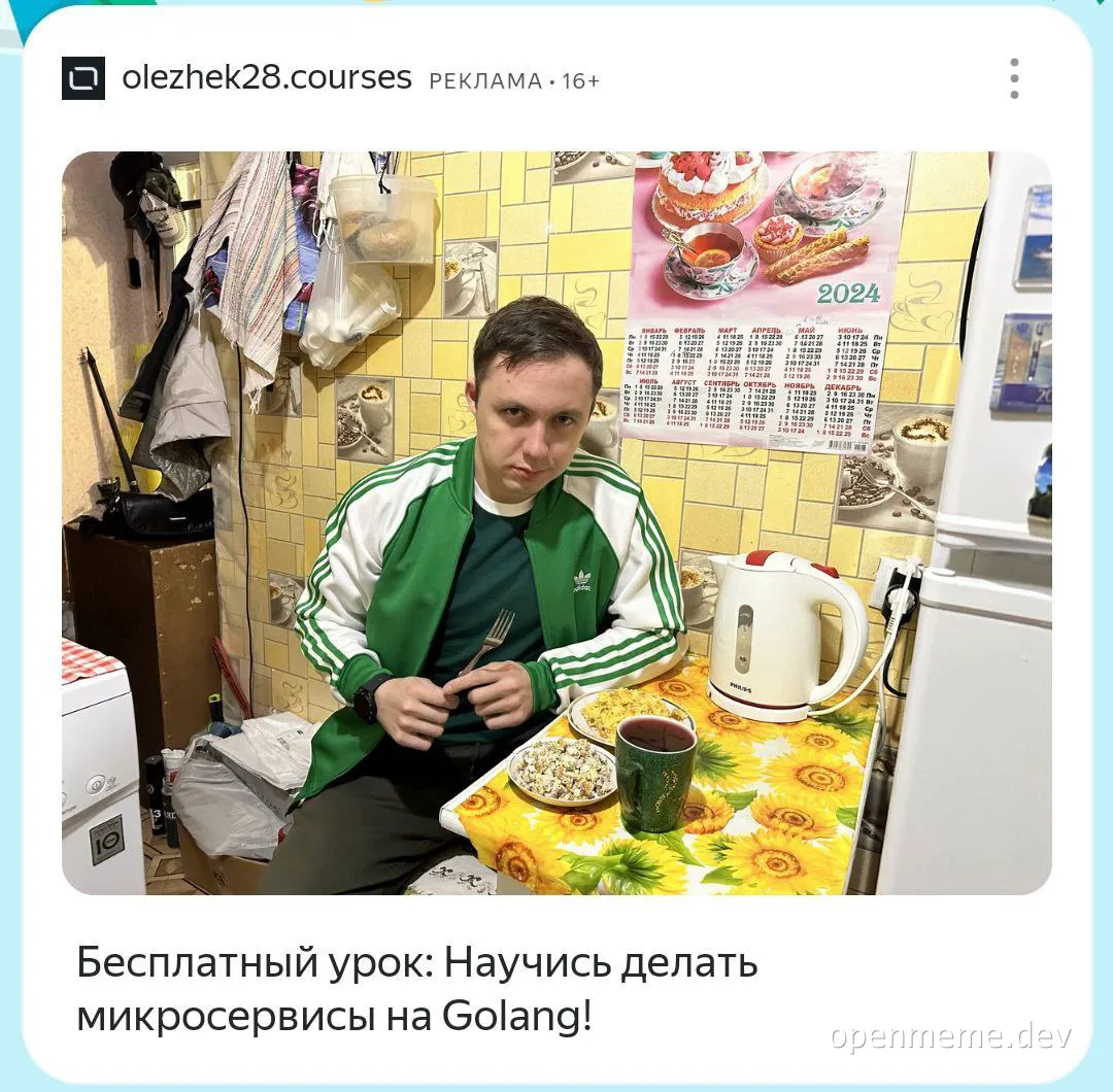 man in green tracksuit sitting at kitchen table with food and drink