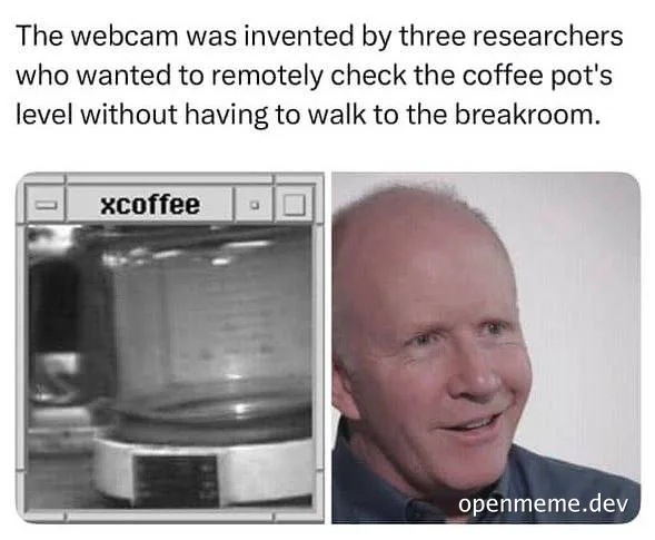 a grayscale webcam image of a coffee pot next to a smiling older man