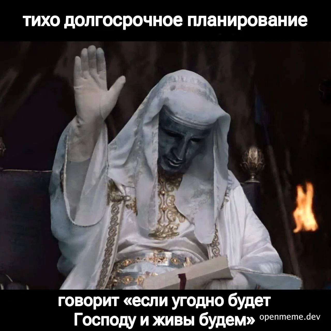 Orthodox priest in white robe with hand raised in prayer