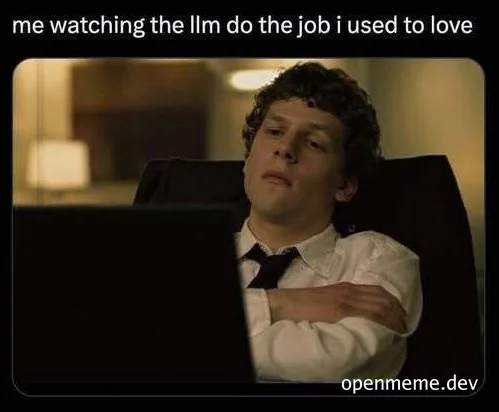 a man sitting at a computer looking disinterested
