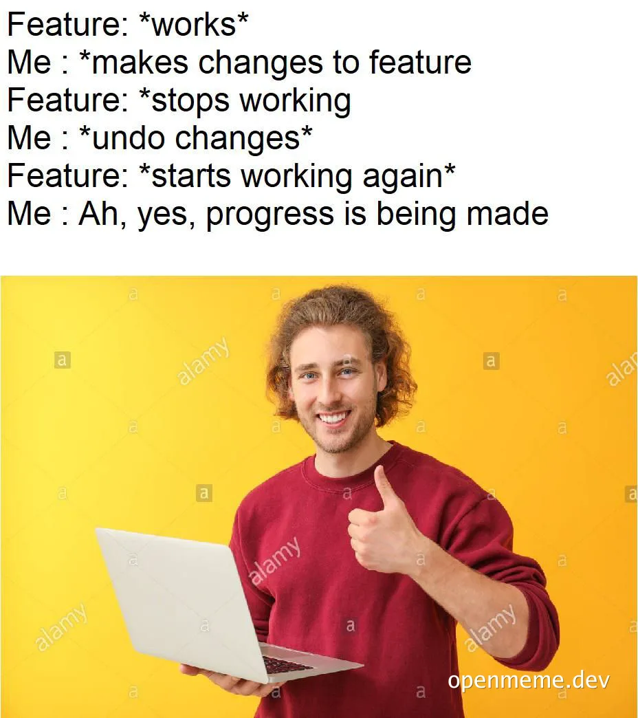 Smiling developer undoing code changes on laptop