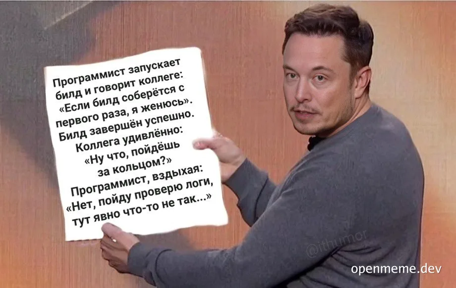 programmer-holds-sign-with-text-about-build-problems