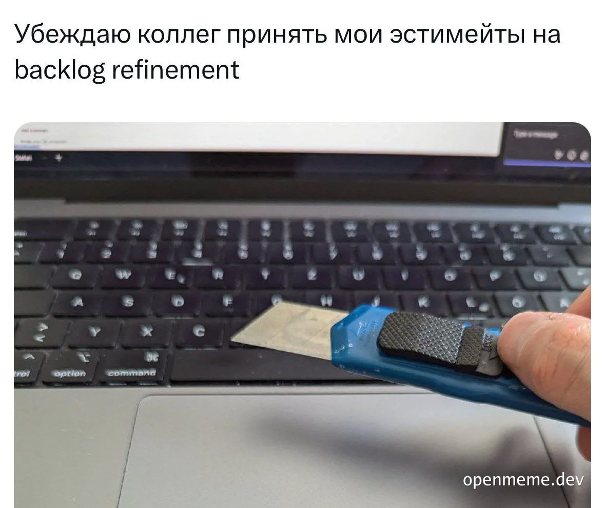 a hand holding a blue utility knife with a gray grip in front of a laptop keyboard