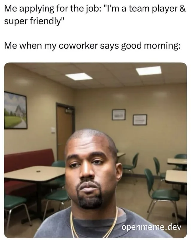 Meme with text 'Me applying for the job: I'm a team player & super friendly' and 'Me when my coworker says good morning:' above a photo of a man with a deadpan, unimpressed expression sitting in an office break room with tables and chairs.