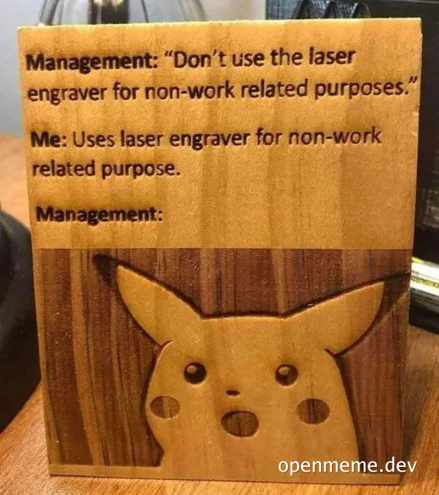 Wooden block with laser-engraved text about non-work usage and a surprised Pikachu face.