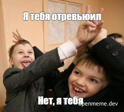 Two boys in suits playfully fighting with their hands up