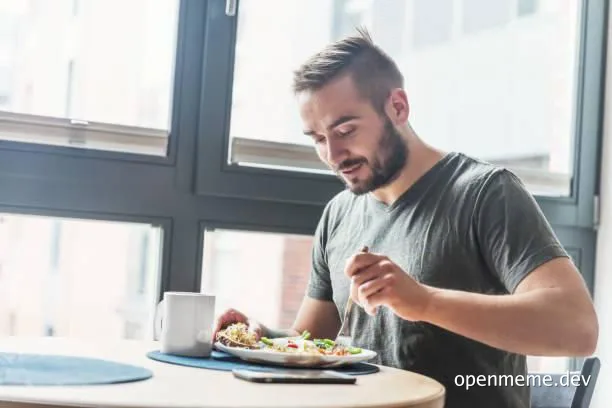 A lonely front end developer eats alone at a table by a window