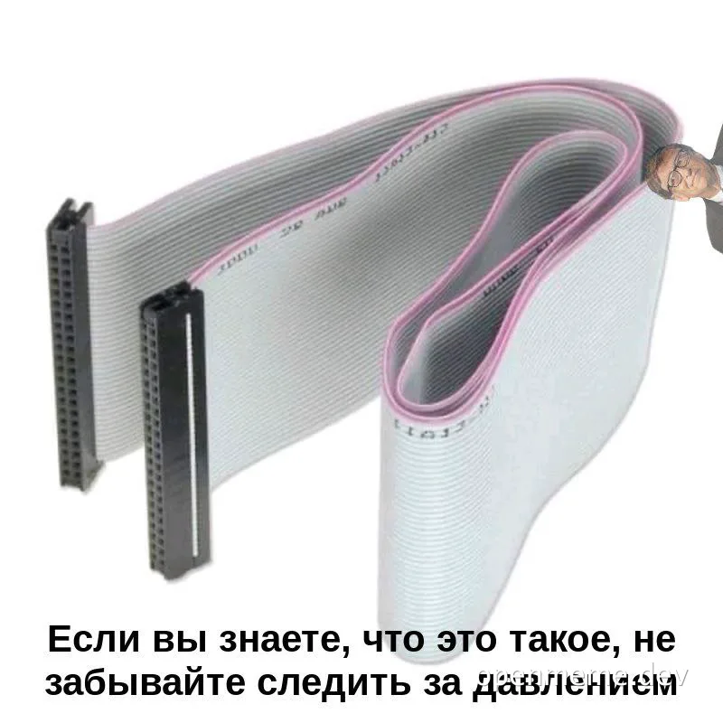 man with glasses looking at a pink and gray cable