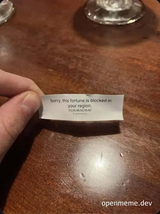 Hand holding a fortune cookie slip that says 'Sorry, this fortune is blocked in your region' with IP numbers.