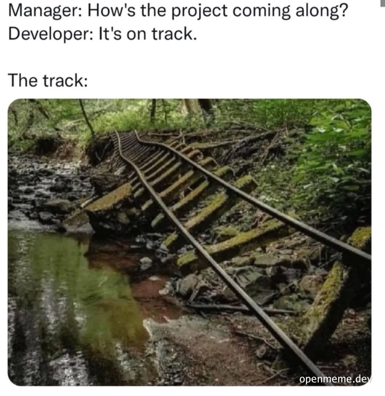 a train track going through a forest with a stream next to it